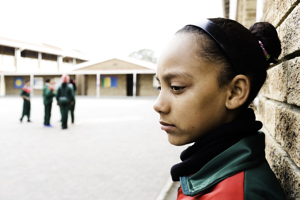 Sad girl outside her school