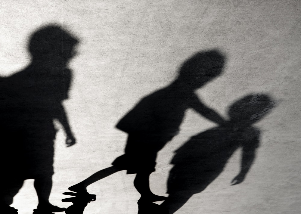 Shadows of school children on a playground