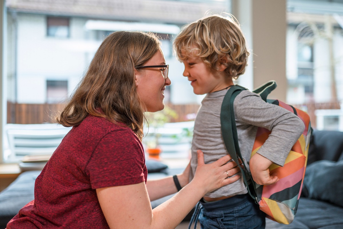 Mother kneeling down to small boy's level