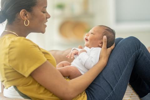 Mother holding and talking to baby